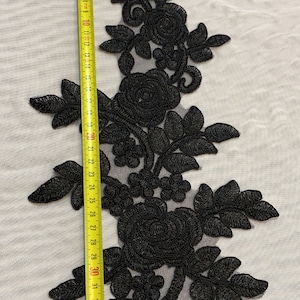 May include: Black floral lace trim with a delicate design. The trim is approximately 38 inches long.