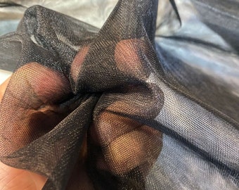 May include: Black sheer mesh fabric with a fine, even weave. The fabric is soft and delicate, with a slight sheen.