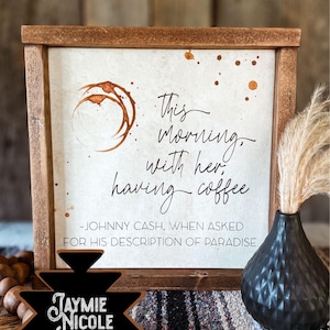 May include: A framed wood sign with a coffee stain design and the text "This morning, with her, having coffee - Johnny Cash, when asked for his description of paradise."