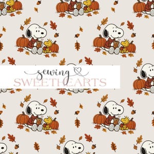 May include: A repeating pattern on a light beige background featuring Snoopy and Woodstock sitting with pumpkins and autumn leaves. Snoopy wears a red jumper and holds a mug. The text "sewing SWEETHEARTS" is overlaid in the centre.