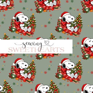 May include: A repeating pattern on a sage green background featuring Snoopy wearing a Santa hat, reading a book while sitting on a red plaid blanket. The design includes Christmas trees, green mugs with hearts, gifts, and red snowflakes.