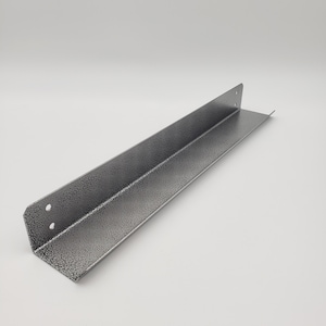 May include: A silver metal corner brace with a textured finish. The brace is L-shaped and has a 90-degree angle.