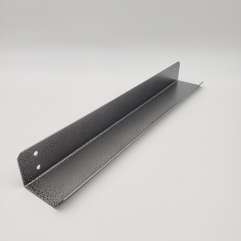 May include: A silver metal corner brace with a textured finish. The brace is L-shaped and has a 90-degree angle.