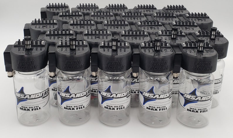 May include: A group of 20 clear plastic bottles with black lids and a black powder dispenser attached to the top. The bottles are labeled "INSANDIT" and "MAX 60 PSI MAX FILL".