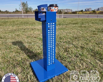 May include: Blue metal cornhole scoreboard with a numbered column from 1 to 21. The scoreboard is on a grassy surface with a download button and file types DXF, SVG, and PDF.