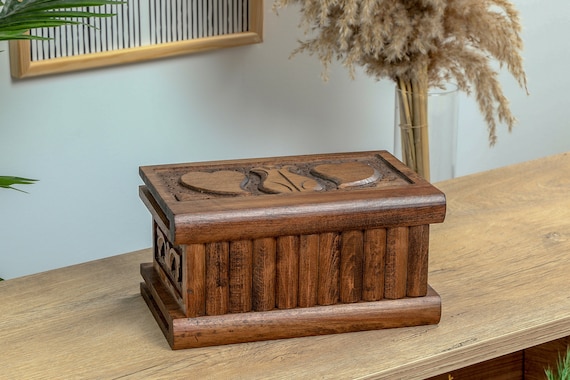 A hand-carved walnut treasure chest that hides its secret behind a heart-engraved key — jewelry storage meets heirloom puzzle.