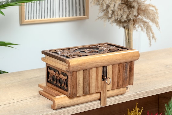 A hand-carved walnut puzzle box with a secret locking mechanism — you have to solve it to get inside, making every unboxing an experience.