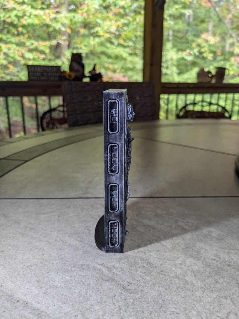 May include: A black and white 3D printed wall decor with a textured surface and a raised design. The decor features a series of rectangular shapes with raised lettering that reads "OPEN", "CLOSE", "PUSH", and "PULL".