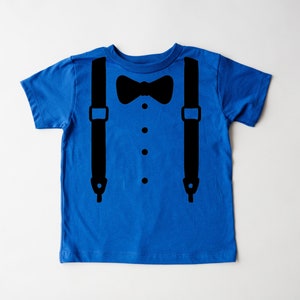 May include: A blue short-sleeved t-shirt with a black bow tie and suspenders graphic.