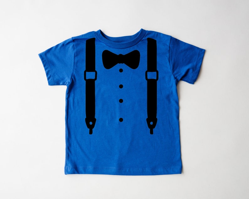 May include: A blue short-sleeved t-shirt with a black bow tie and suspenders graphic.