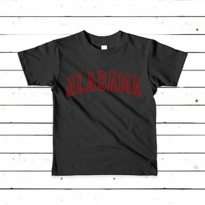 May include: Black t-shirt with a red outline of the word "ALABAMA" printed on the front.