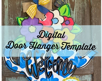 May include: Digital door hanger template featuring a blue teapot with white hearts and the word "Welcome" in black script. The teapot is decorated with colorful flowers and green leaves. The template is for personal use only.