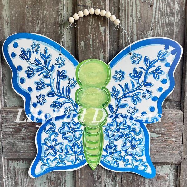 Colgador de puerta con mariposa azul y blanca
