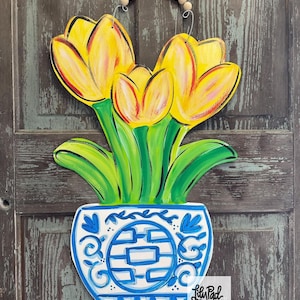 Yellow tulips in chino pot door hanger