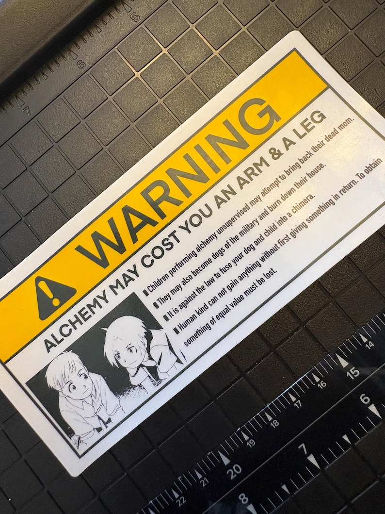 A warning sticker with a yellow banner that states “WARNING ALCHEMY MAY COST YOU AN ARM AND A LEG” and features a picture of the Elric brothers performing human transmutation. There are bullet points outlining the risks of performing alchemy.