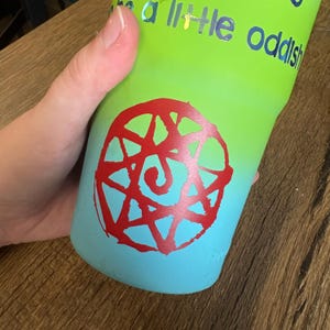 An example of the Blood Seal decal in red placed on a blue-green tumbler.