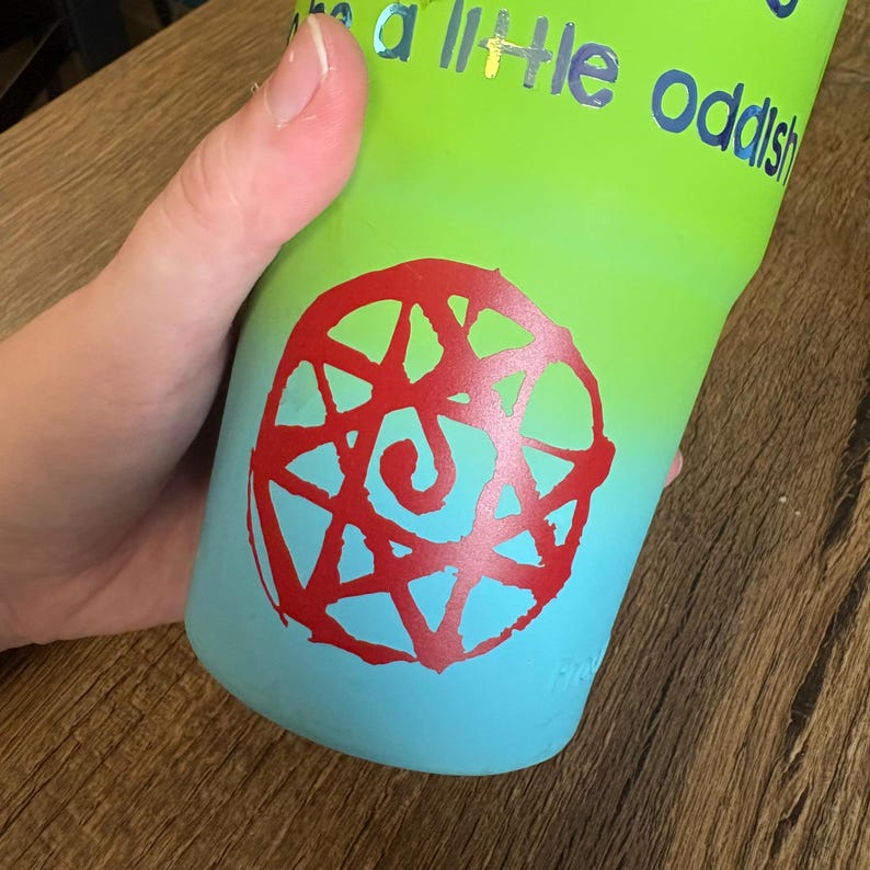 An example of the Blood Seal decal in red placed on a blue-green tumbler.