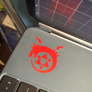 Another example of the Homunculus decal in red placed on an iPad case.