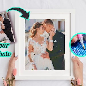 May include: A white framed picture of a couple in wedding attire, with a close-up of a diamond painting in progress in the corner. The couple is embracing and looking at each other. The diamond painting is a blue and green mosaic.