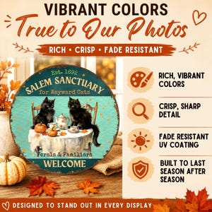 May include: A round metal sign featuring two black cats sitting at a table with a tea set and pumpkins. The text reads SALEM SANCTUARY for Wayward Cats, Est. 1692, Ferals & Familiars, and WELCOME. The sign highlights rich, vibrant colors and fade-resistant quality.