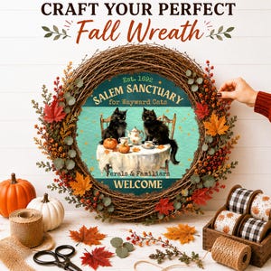 May include: A round grapevine wreath decorated with autumn leaves and berries, featuring a central sign that reads SALEM SANCTUARY for Wayward Cats Est. 1692, depicting two black cats at a table with tea and pumpkins, with the text WELCOME below.