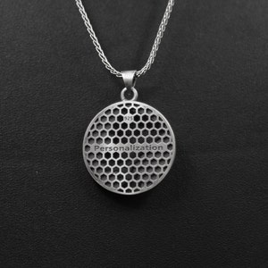 May include: Silver pendant necklace with a round, honeycomb-patterned disc. The disc has the word "Personalization" engraved on it and the number "925" stamped on the back.