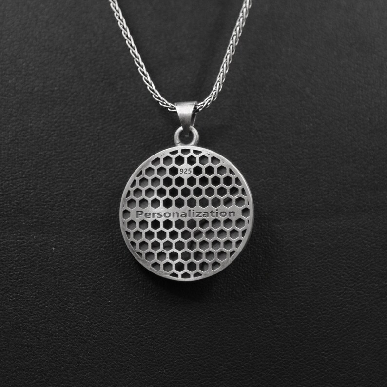 May include: Silver pendant necklace with a round, honeycomb-patterned disc. The disc has the word "Personalization" engraved on it and the number "925" stamped on the back.