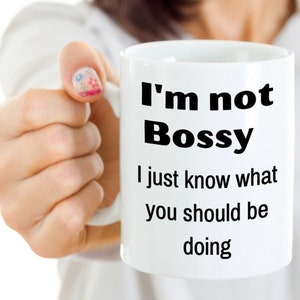 May include: White ceramic coffee mug with black text that reads "I'm not Bossy I just know what you should be doing."