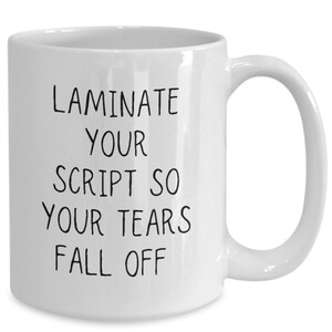 May include: White ceramic coffee mug with black text that reads "Laminate your script so your tears fall off."