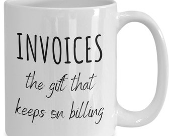 May include: White ceramic mug with a curved handle. The mug features the text "INVOICES the gift that keeps on billing" in black, handwritten-style lettering. A humorous gift for someone in accounting or finance.