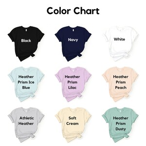 May include: Color chart showing different t-shirt colors, including black, navy, white, heather prism ice blue, heather prism lilac, heather prism peach, athletic heather, soft cream, and heather prism dusty.