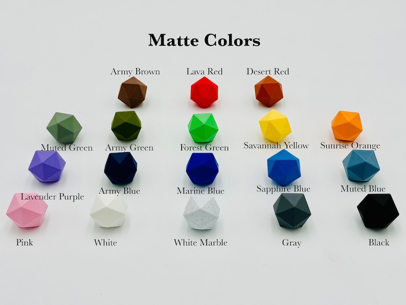 May include: A chart of 16 different colours of matte geometric shapes. The colours include army brown, lava red, desert red, muted green, army green, forest green, savannah yellow, sunrise orange, lavender purple, army blue, marine blue, sapphire blue, muted blue, pink, white, white marble, grey, and black.