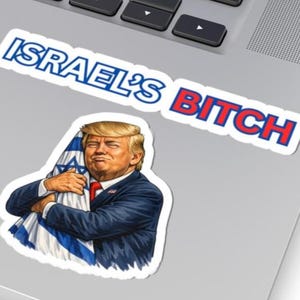 May include: A sticker featuring a cartoon image of a man in a suit hugging an Israeli flag. The sticker also has the text "ISRAEL'S BITCH" in blue and red lettering.