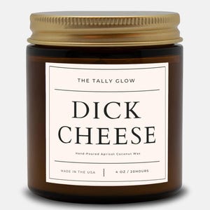 May include: A brown glass jar with a gold lid, labeled "DICK CHEESE" in bold black letters. The label also includes "THE TALLY GLOW" and "Hand-Poured Apricot Coconut Wax." The jar contains 4 oz and is made in the USA.