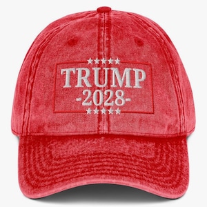 May include: Red vintage style baseball cap with white embroidered text that reads "TRUMP -2028- " with five stars above and below the text.
