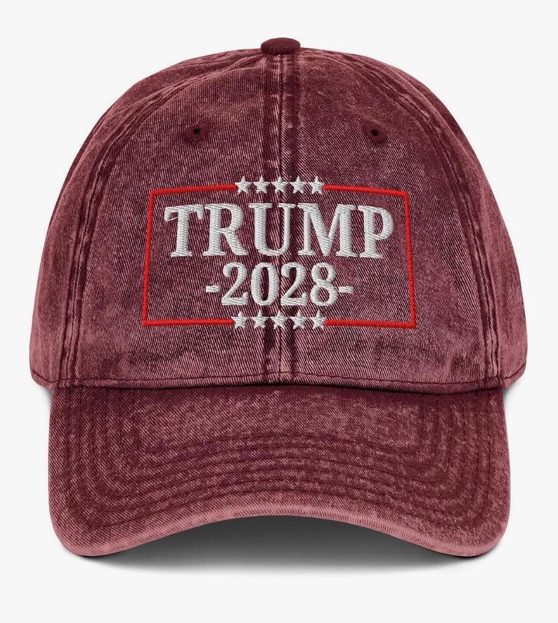 May include: A red vintage baseball cap with a white embroidered logo that says "TRUMP -2028- ". The logo is surrounded by a red border and five white stars on each side.