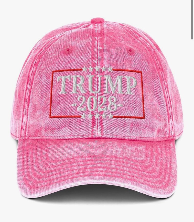 May include: Pink distressed baseball cap with white embroidered text that reads "TRUMP 2028" inside a red rectangle with white stars above and below the rectangle.