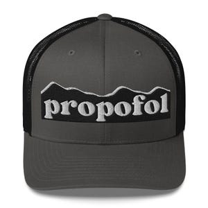 May include: A gray trucker hat with a black mesh back. The front features a black rectangle with the word "propofol" in white, above a white mountain range design.
