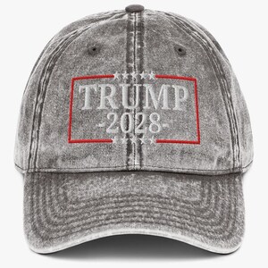 May include: A gray, distressed, cotton baseball cap with a red and white embroidered design that says "TRUMP 2028".