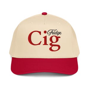 May include: A baseball cap in cream and red. The cap has a red peak and a red button on top. The word "Cig" is in large red letters, with "Fridge" in smaller black script above it.