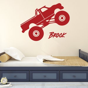 May include: Red monster truck wall decal with the name Brock written in a bold, red font.