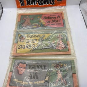 May include: A sealed package of 18 mini-comics, with the text "Great Trick or Treat and Kids' Party Idea." The comics are in individual plastic sleeves. The titles include "Believe It or Not!", "Grimms Ghost Stories", and "The Twilight Zone".