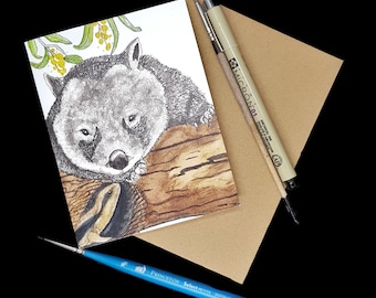 May include: A watercolor illustration of a wombat resting on a tree trunk. The wombat is drawn in shades of gray and brown, with a detailed depiction of its fur. The background is a light brown color, suggesting a natural setting.