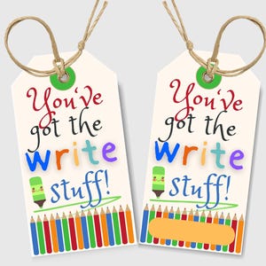 May include: Two cream-colored gift tags with the text "You've got the Write stuff!" in colorful letters. Each tag has a green pencil graphic and a row of colorful pencils at the bottom. The tags are tied with twine.