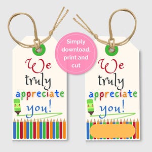 May include: Two cream-colored gift tags with the text "We truly appreciate you!" in colorful letters. Each tag has a green marker illustration and a row of colored pencils at the bottom. The tags are tied with twine.