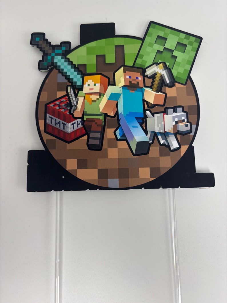May include: A Minecraft cake topper with pixelated characters Steve and Alex, a white dog, a creeper, a sword, and a TNT block. The topper is attached to clear plastic sticks for easy insertion into a cake.
