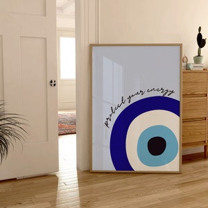 May include: A framed print with a blue and white evil eye design and the text "protect your energy".