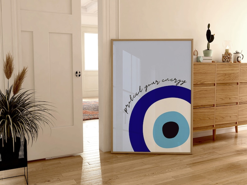 May include: A framed print with a blue and white evil eye design and the text "protect your energy".