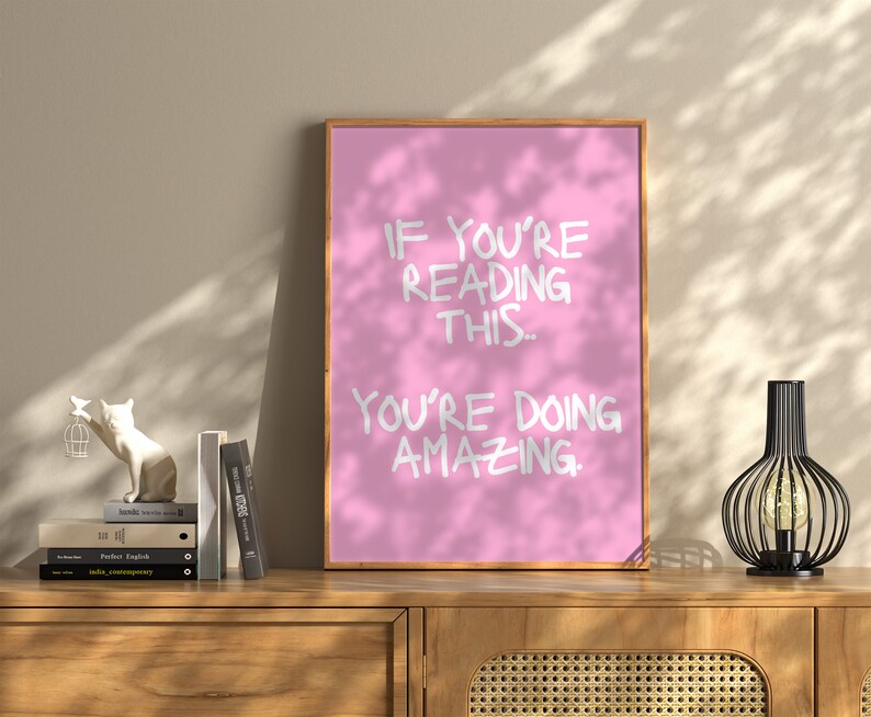 May include: Pink motivational poster with white text that reads "If you're reading this, you're doing amazing."
