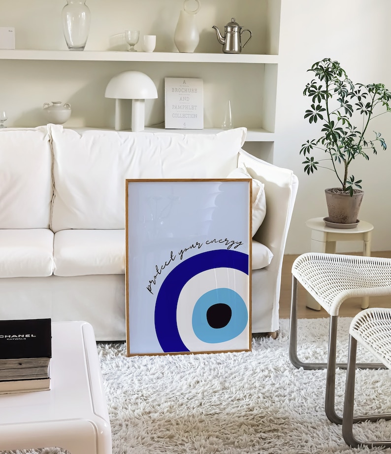 May include: A framed print with a blue and white evil eye design and the text "Protect your energy".